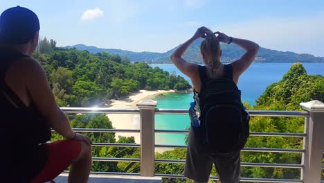 Two-travellers-enjoying-the-view-to-a-hidden-beach