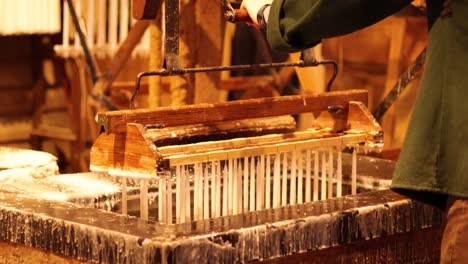 crafting candles in a historical setting