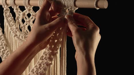 Close up of hands macrame wall hanging
