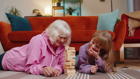 grandmother and granddaughter having fun playing a game together