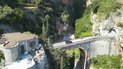 aerial pullback reveals bridge above fiordo di furore