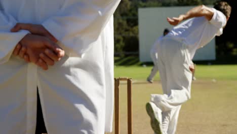 bowler delivering ball during cricket match