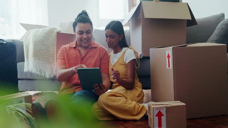 happy couple in new house with boxes