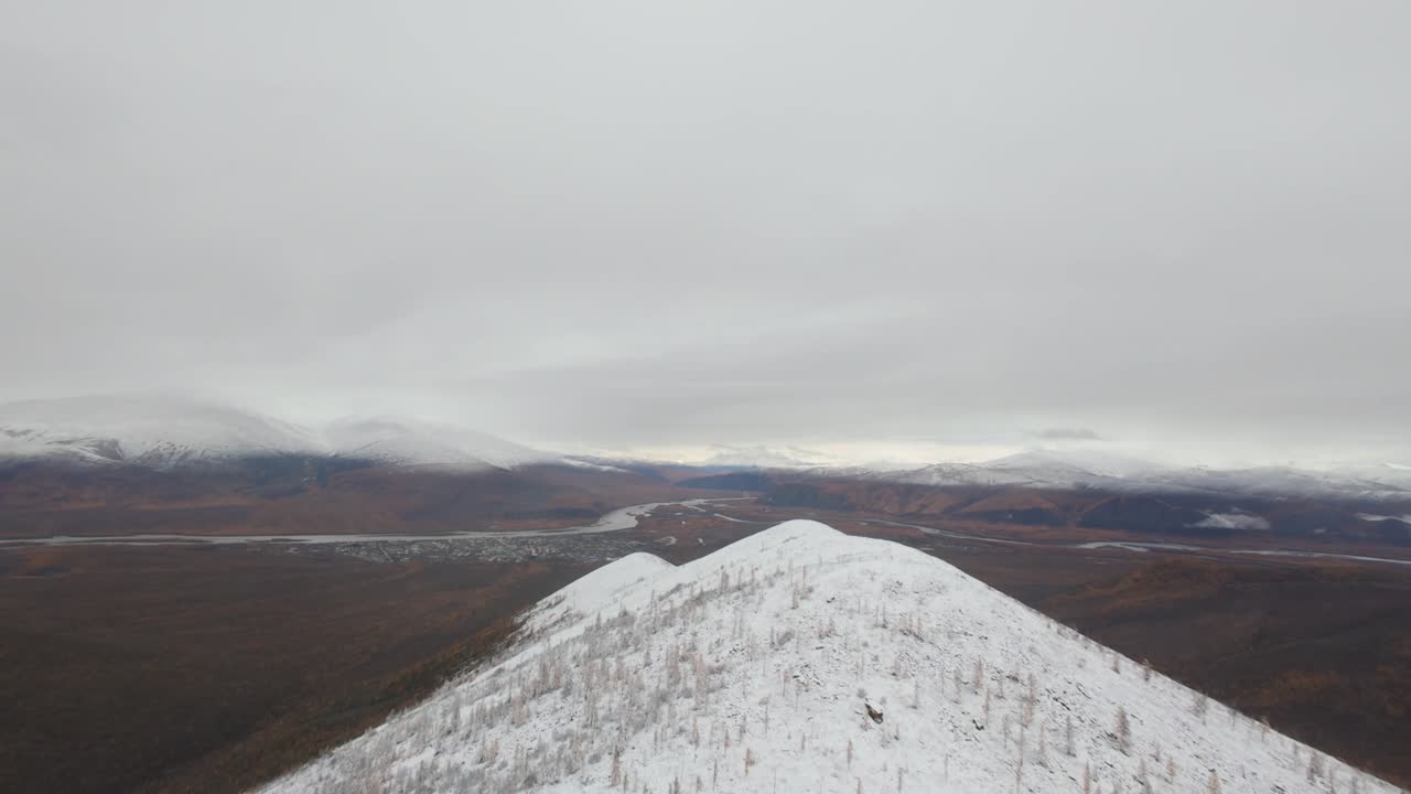 Aerial View of Snowy Mountain Range and Rock Formations