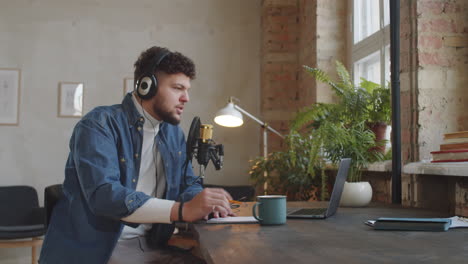 man hosting podcast in recording studio