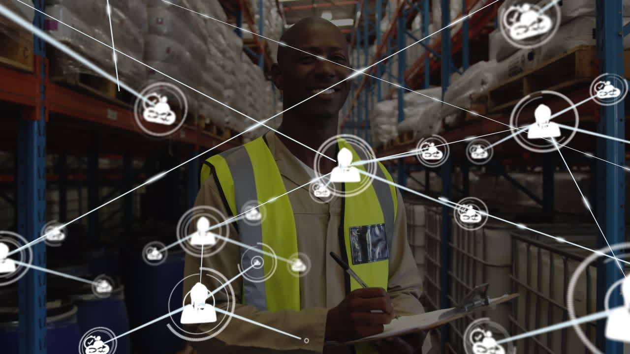 Animation of icons connected by lines over smiling african american man with checklist in warehouse
