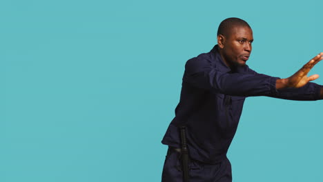 portrait of stern bodyguard pushing back unwanted visitors