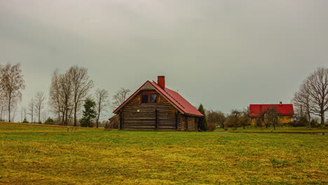 sunrise over a summer cottage in a green field surrounded by trees