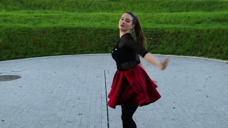 dolly out of an beautiful female dancer in the park