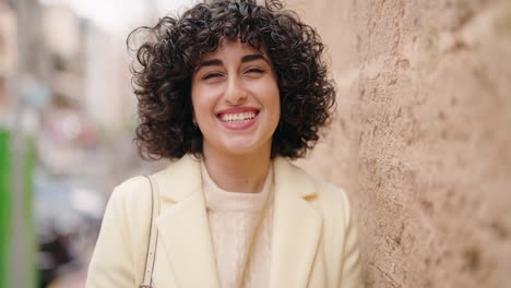young woman smiling confident standing at street