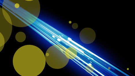 animation of yellow spots over glowing blue light trails against black background with copy space