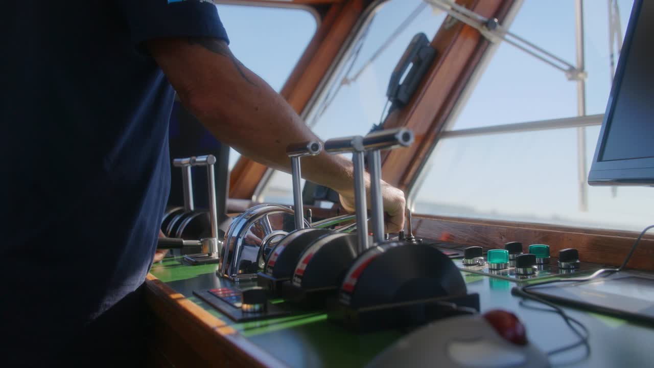 Captain of a boat operating the ship on a sunnyday in slowmotion