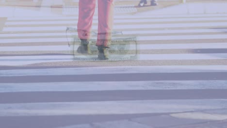 Composite-video-of-american-dollar-bills-falling-against-low-section-of-a-person-crossing-the-street