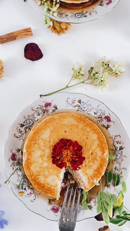 beautiful stacked pancakes with floral garnish