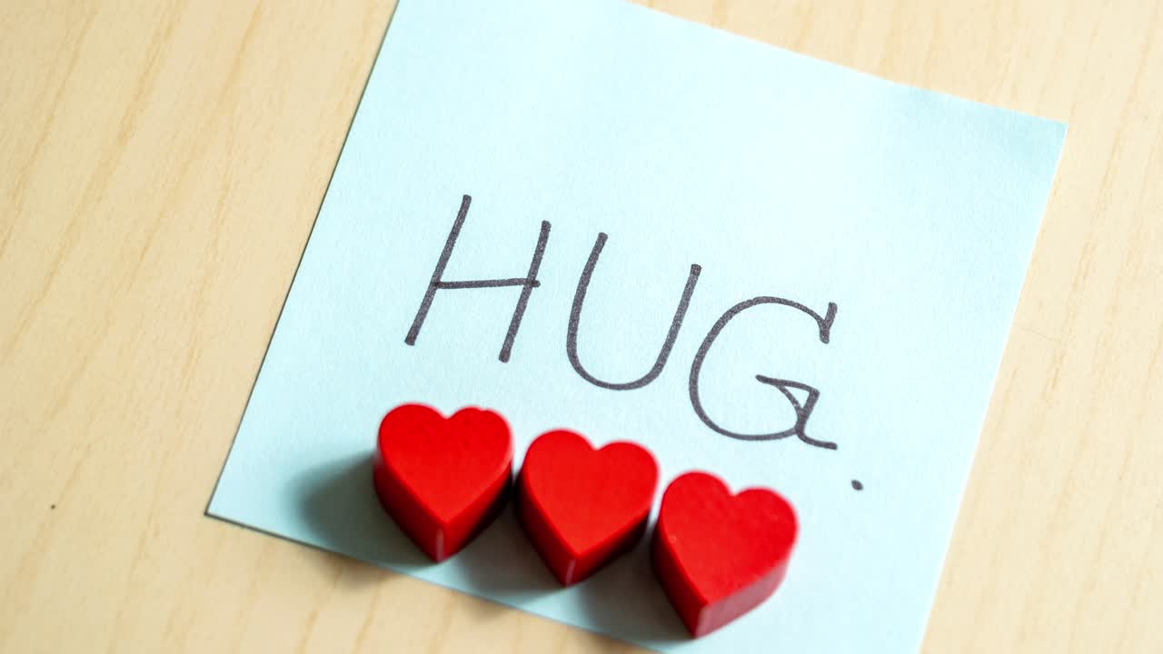 A touching moment captured as three hearts express love through a simple hug note.