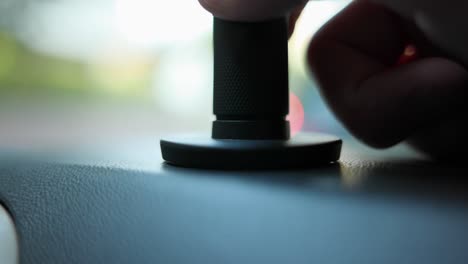 Close-Up-Shot-Of-Action-Camera-Mount-Being-Detached-From-Dashboard-Inside-Car