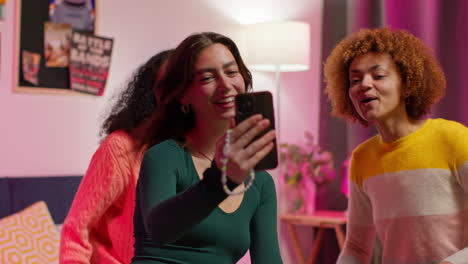 friends taking a selfie in a bedroom