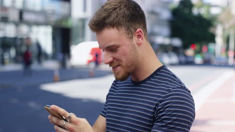 man using smartphone in city street