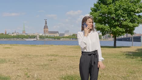 caucasian business woman calling with smartphone on business trip in riga