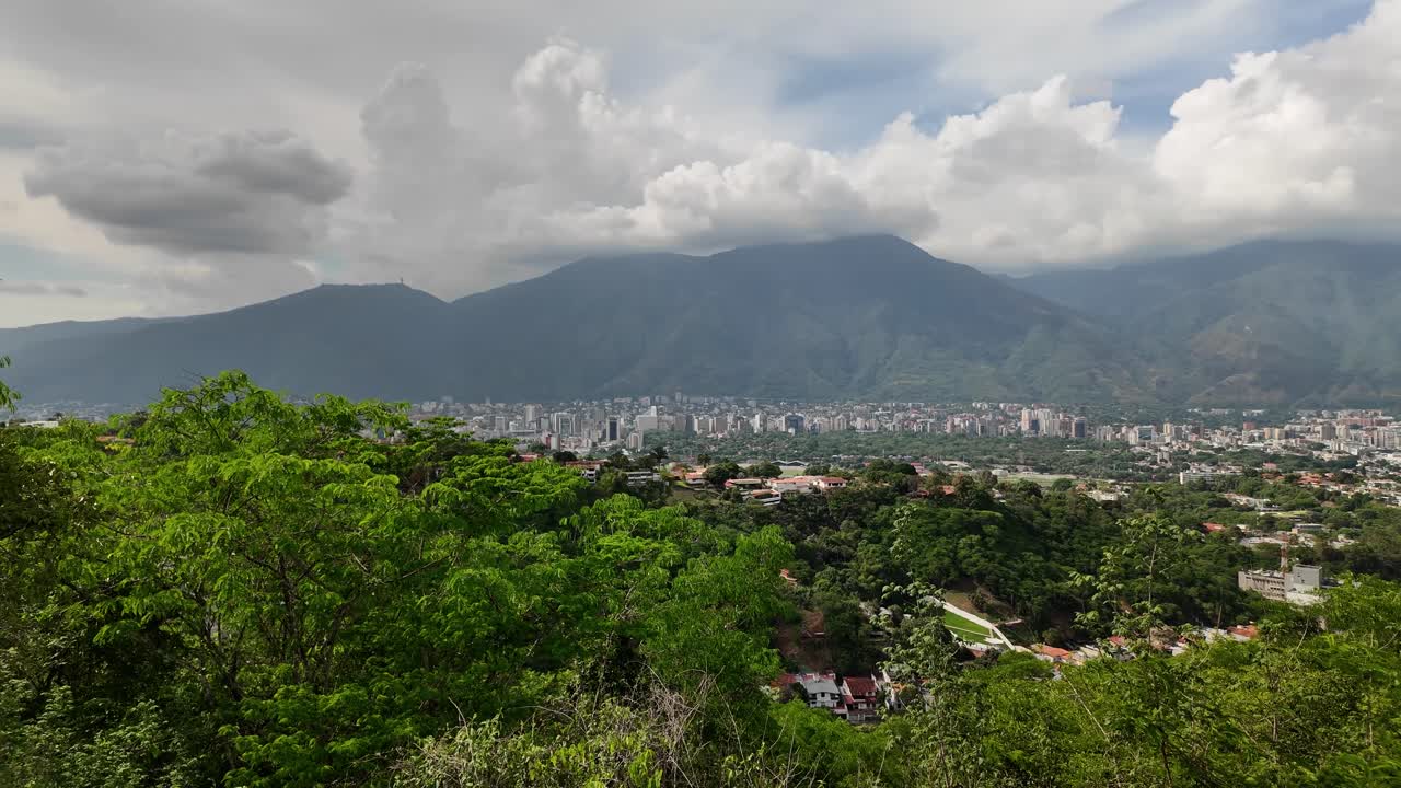 View of the city of Caracas from the La Fila Natural Park viewpoint, Cerro Avila Background. Pan left