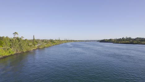 flying above calm waters of tweed river in chinderah, nsw, australia