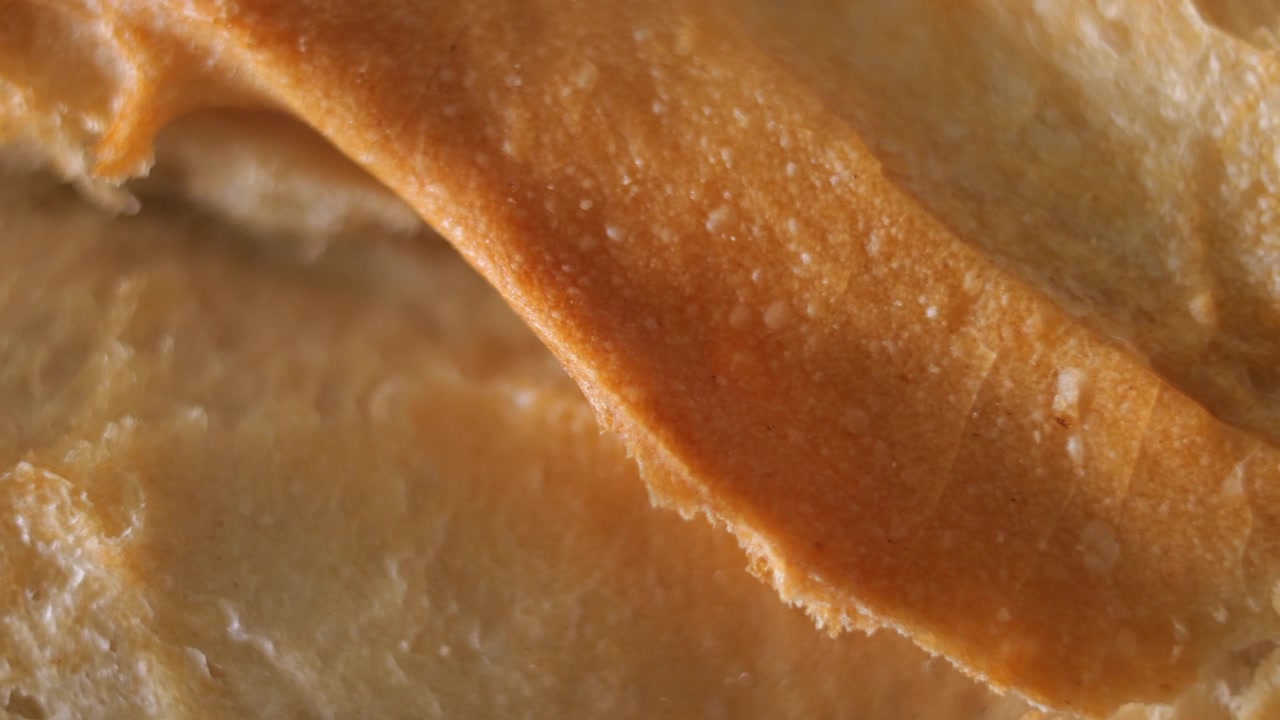 50p macro slider shot moving above the crust of artisan bread