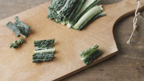 chopped kale on a wooden cutting board