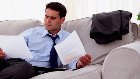 Concentrated-businessman-working-on-a-couch