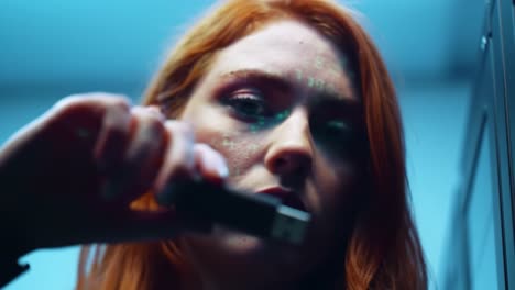 a close-up of a focused individual with orange hair, analyzing glowing code on their face in a digital environment, showcasing themes of technology and contemplation