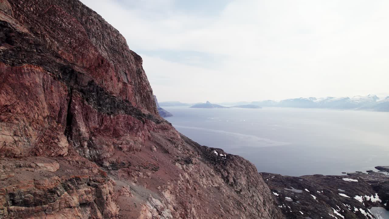 Stunning Aerial View of the Uummannaq Mountain in Greenland - Dolly Shot flying along the rocky mountainside