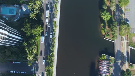 ala wai waterway in honolulu, top down aerial view, tilt up reveals cityscape