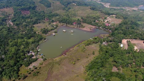 marvelous 4k daytime aerial view looking over the tropical rain forest rural area of tingo maria, centering the laguna de los milagros, famous tourist attraction