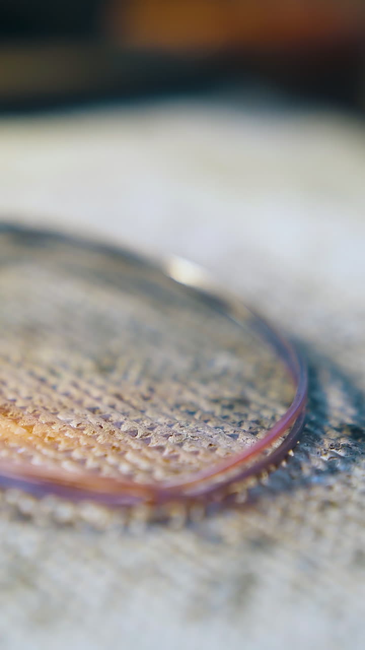 CU: heating of white gold rod ring with gas burner flame on insulation material in light jewelry workshop close view