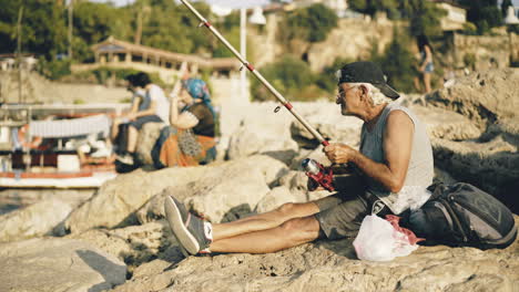 senior man fishing by the sea