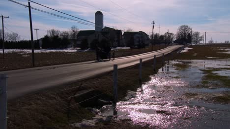 Amish-horse-cart-rolls-along-a-road-in-rural-Pennsylvania