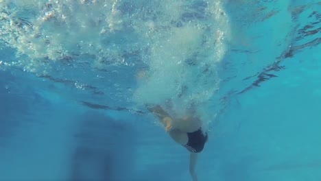 athletic swimmer swimming in pool