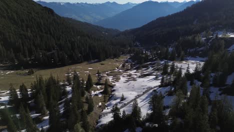 Drone-shot-of-Austrian-Alps-surrounded-by-Pine-Forest-and-Mountains,-Austria,-Europe