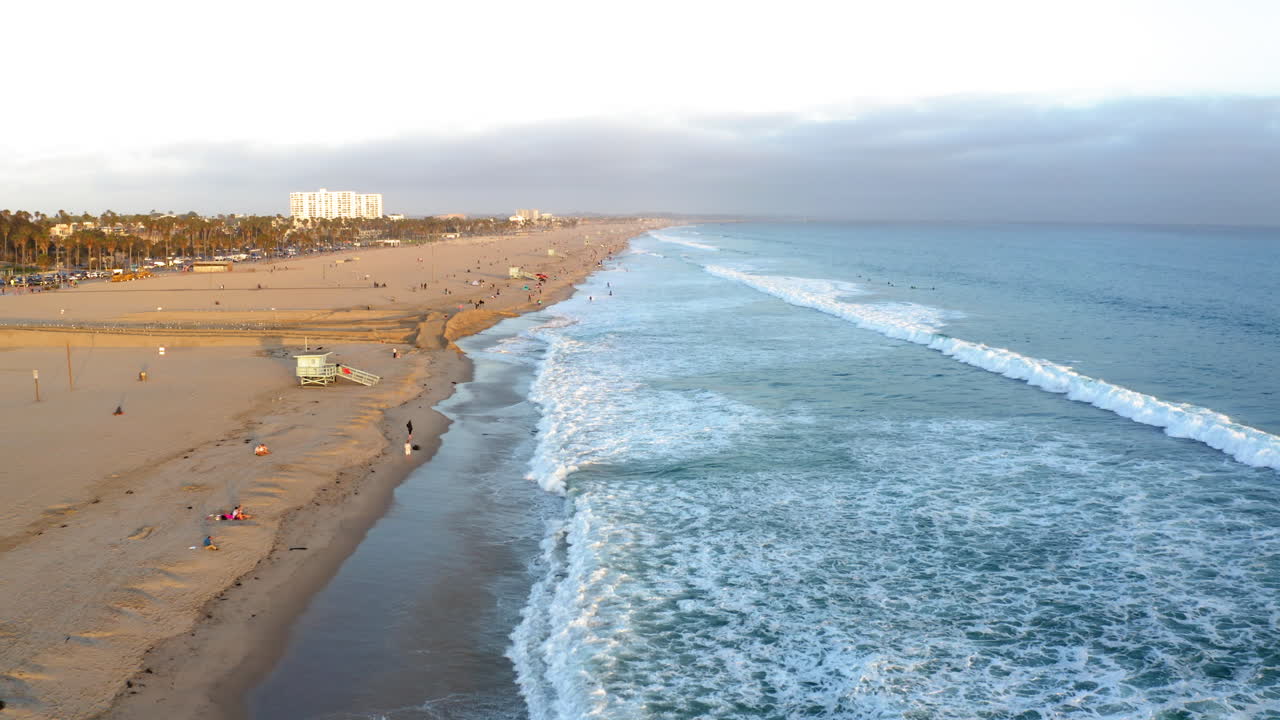 Aerial View of a Popular Beach with Waves and Coastal Skyline