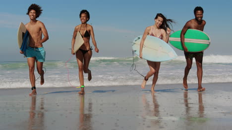 Group-of-friends-running-with-surfboard-4k