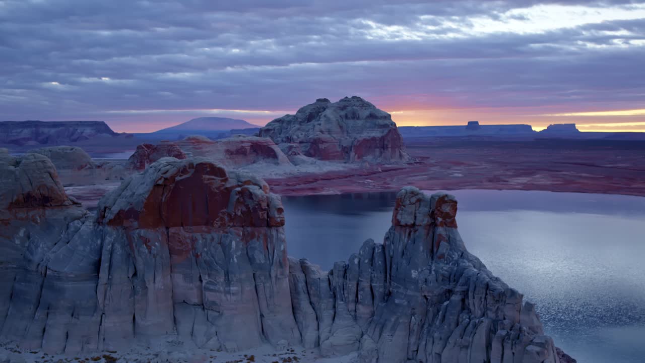 The aerial camera gracefully encircles the rugged sandstone formations of Glen Canyon, revealing the timeless artistry of nature.