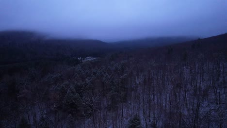 aerial drone video footage of magical foggy night in the snowy appalachian mountains during winter, in the catskill mountains sub-range