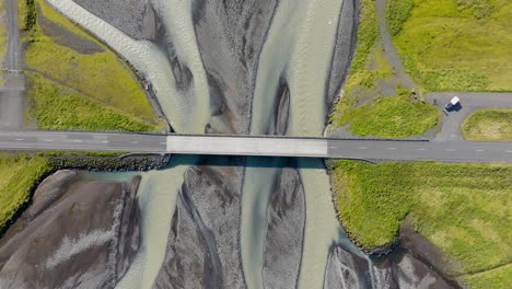 birdseye drone shot descending above a bridge above a river delta in iceland
