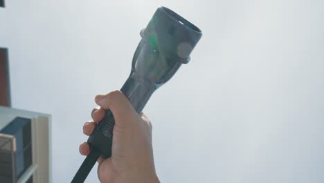 closeup hand grasping an ev plug for electric vehicle as progressive idea.