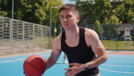 athletic man in sportswear playing basketball game successfully throws ball into the basket ring