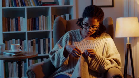 woman knitting at night