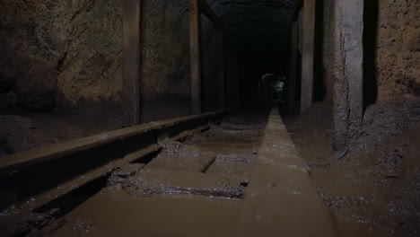 dark and muddy mine tunnel