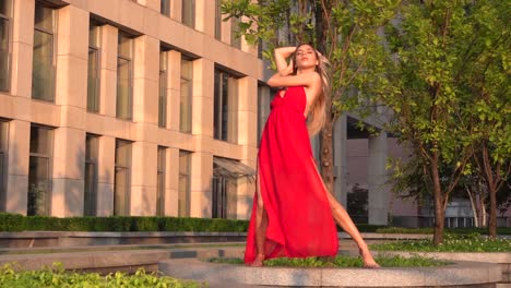 woman in red dress posing outdoors in cityscape