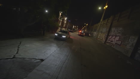 drone shot view of following police cars patrol at night in los angeles, georgia