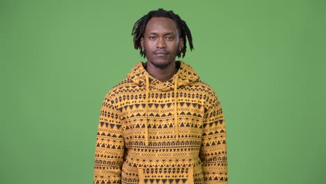 Young handsome African man pointing up