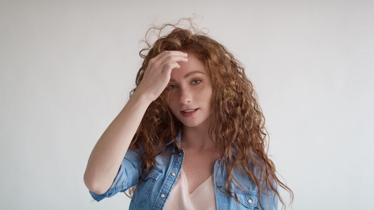 tudio ha girato un video di una giovane donna dai capelli rossi con i capelli grandi